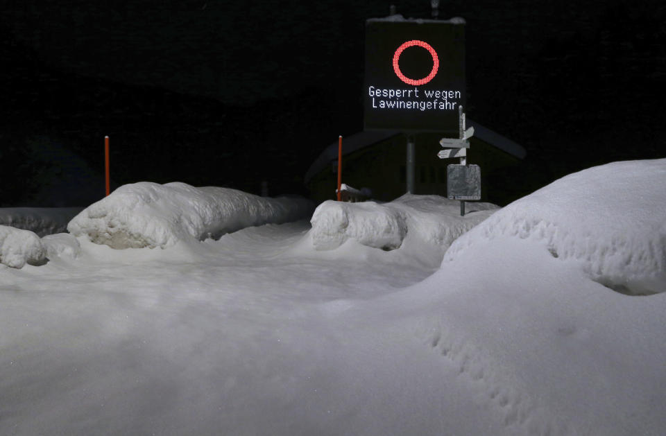 A snow covered road is closed due to the danger of an avalange in Obermailselstein, Germany, Tusday, Jan. 15, 2019. (Josef Hildenbrand/dpa via AP)