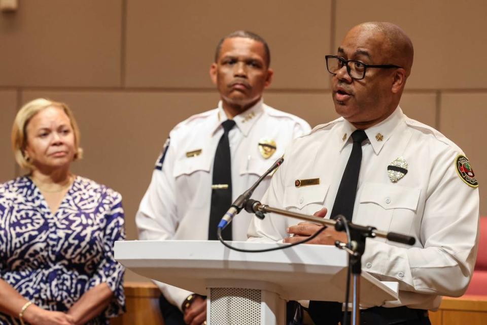 Fire Chief Reginald Johnson, far right, answers media questions following the fire department’s efforts extinguishing the five-alarm fire that tore through a construction site yesterday in South Park.