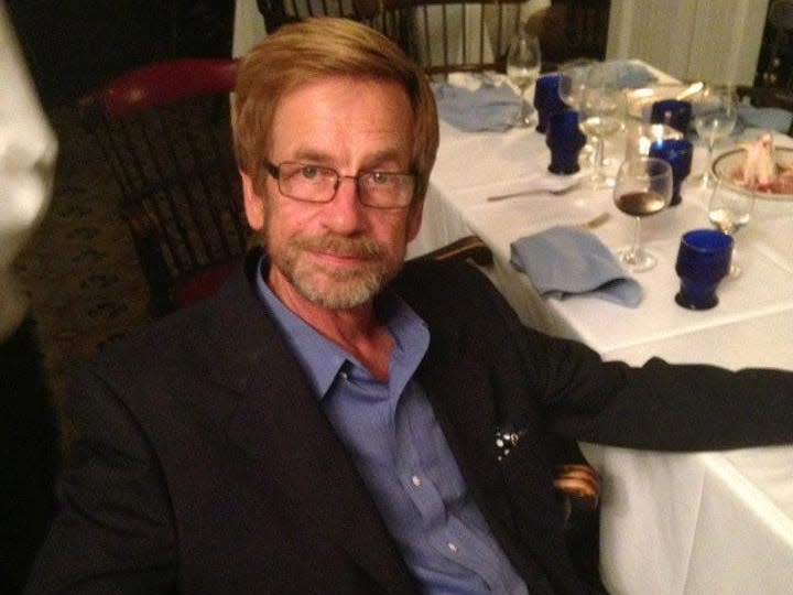 Fugitive Ted Conrad sitting at a dinner table