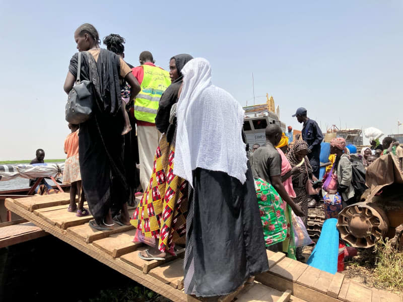 Women gather, among the countless civilians who have fled Sudan's year-old deadly conflict for safety, enduring harsh conditions in makeshift refugee camps over the border with South Sudan. Eva Krafczyk/dpa