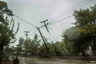 Damaged power and telecommunication lines are seen during a storm at the port of Argostoli, on the Ionian island of Kefalonia, western Greece, Friday, Sept. 18, 2020. A powerful tropical-like storm named Ianos battered the western islands of Zakynthos, Kefalonia, and Ithaki overnight, causing flash flooding, property damage, power outages, and road closures mostly from downed trees, police and local authorities said. (AP Photo/Nikiforos Stamenis)