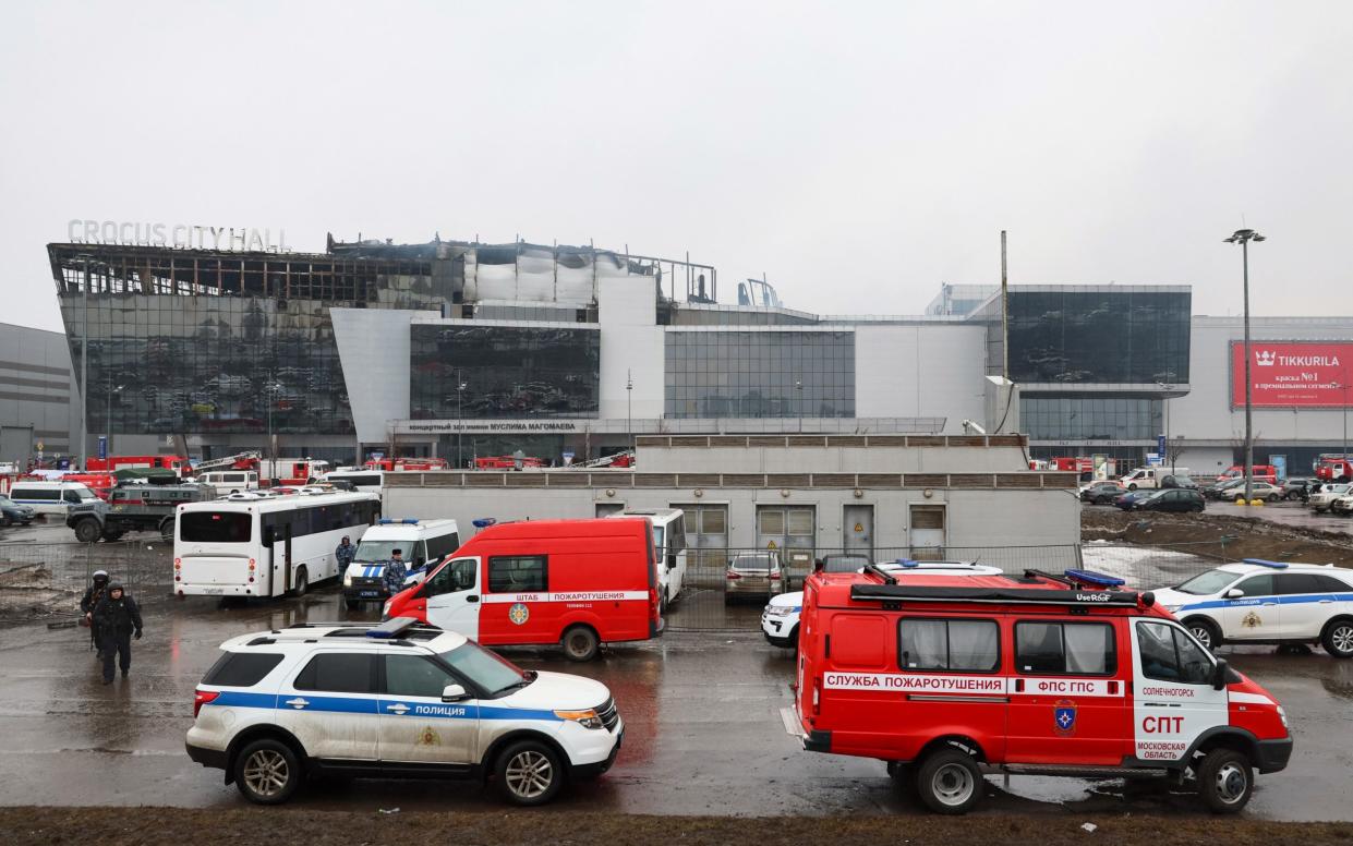 Emergency services personnel and police work at the scene of the gun attack at the Crocus City Hall concert hall in Krasnogorsk, outside Moscow.