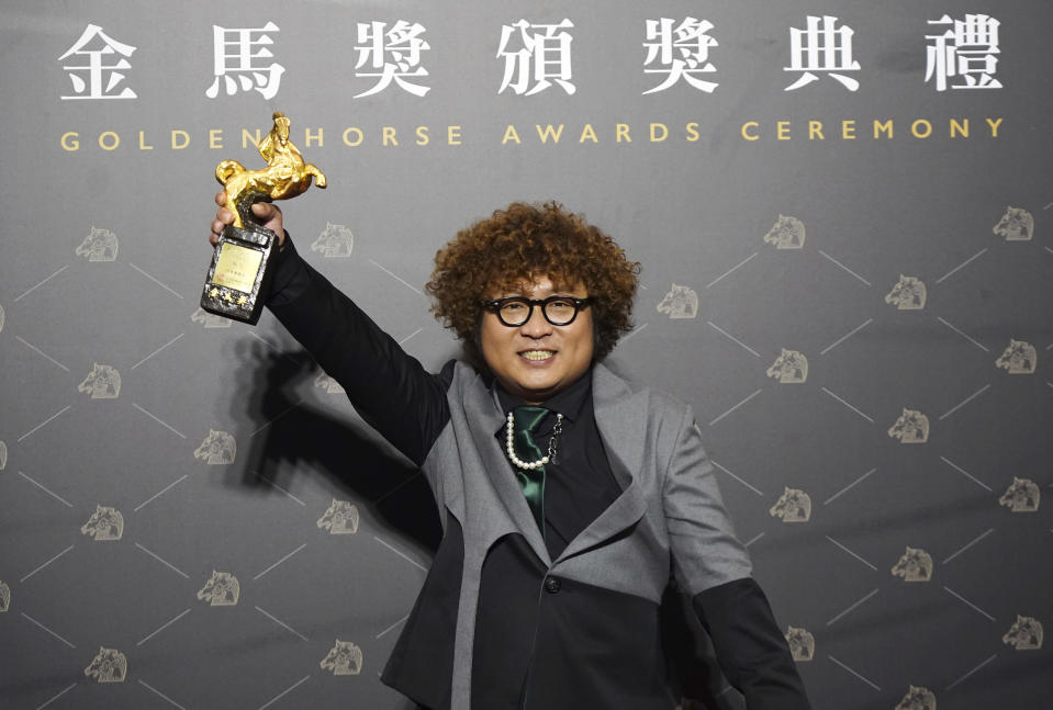 Taiwanese actor Nadow Lin holds his award for Best Supporting Actor at the 57th Golden Horse Awards in Taipei, Taiwan, Saturday, Nov. 21, 2020. Lin won for the film "Classmates Minus" at this year's Golden Horse Awards. (AP Photo/Billy Dai)