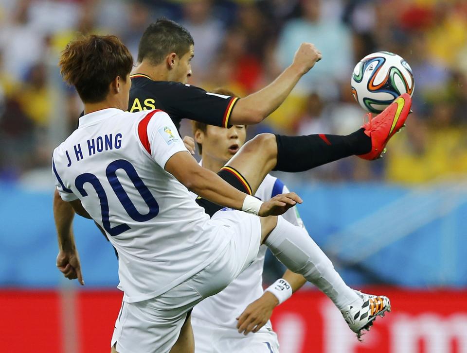 South Korea's Hong Jeong-ho fights for the ball with Belgium's Kevin Mirallas during their 2014 World Cup Group H soccer match at the Corinthians arena