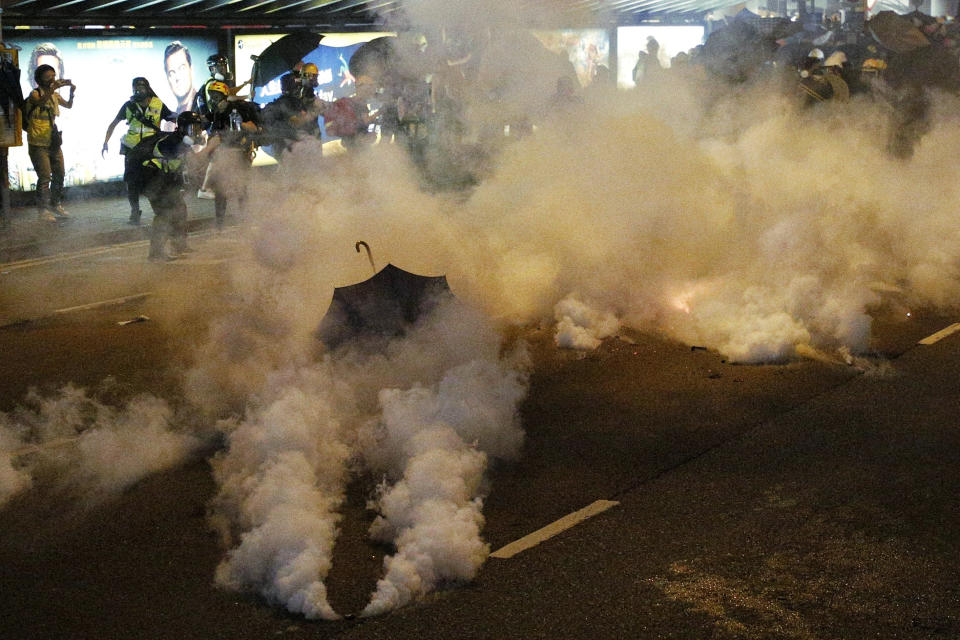 Protesters are engulfed by teargas during a confrontation with riot police in Hong Kong Sunday, July 21, 2019. Hong Kong police launched tear gas at protesters Sunday after a massive pro-democracy march continued late into the evening. The action was the latest confrontation between police and demonstrators who have taken to the streets to protest an extradition bill and call for electoral reforms in the Chinese territory. (Jacky Cheung/HK01 via AP)
