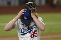 Los Angeles Dodgers starting pitcher Dustin May reacts after giving up a two-run home run to Tampa Bay Rays' Brandon Lowe during the fifth inning in Game 2 of the baseball World Series Wednesday, Oct. 21, 2020, in Arlington, Texas. (AP Photo/Eric Gay)