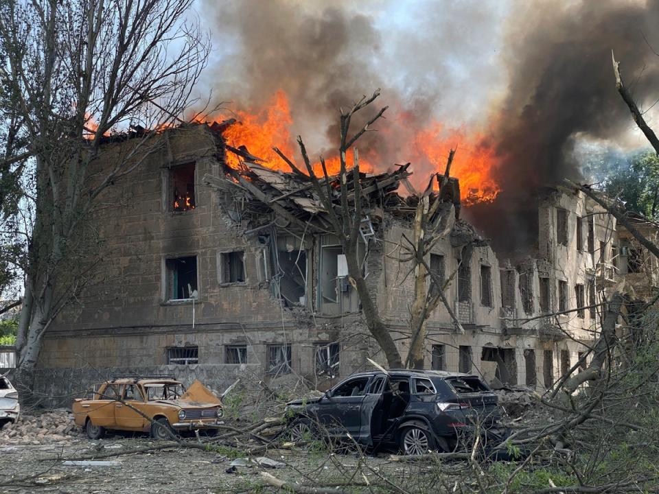 Firefighters hose down a policlinic following a Russian attack in Dnipro on Friday (AP)