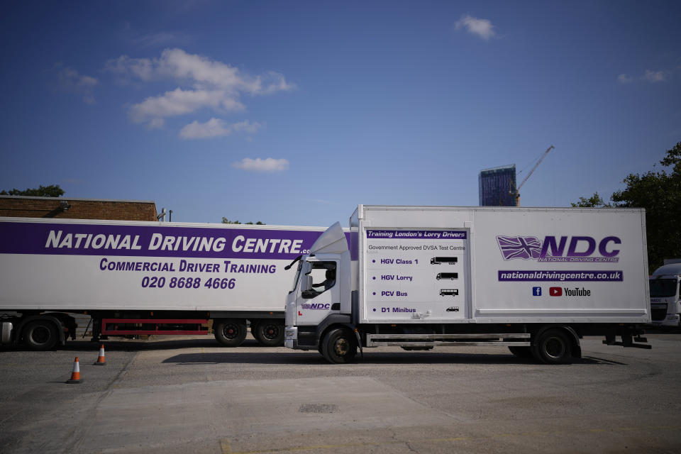 An instructor drives whilst training a learner truck driver sat next to him in the truck cab, at the National Driving Centre in Croydon, south London, Wednesday, Sept. 22, 2021. Britain doesn't have enough truck drivers. The shortage is contributing to scarcity of everything from McDonald's milkshakes to supermarket produce. (AP Photo/Matt Dunham)