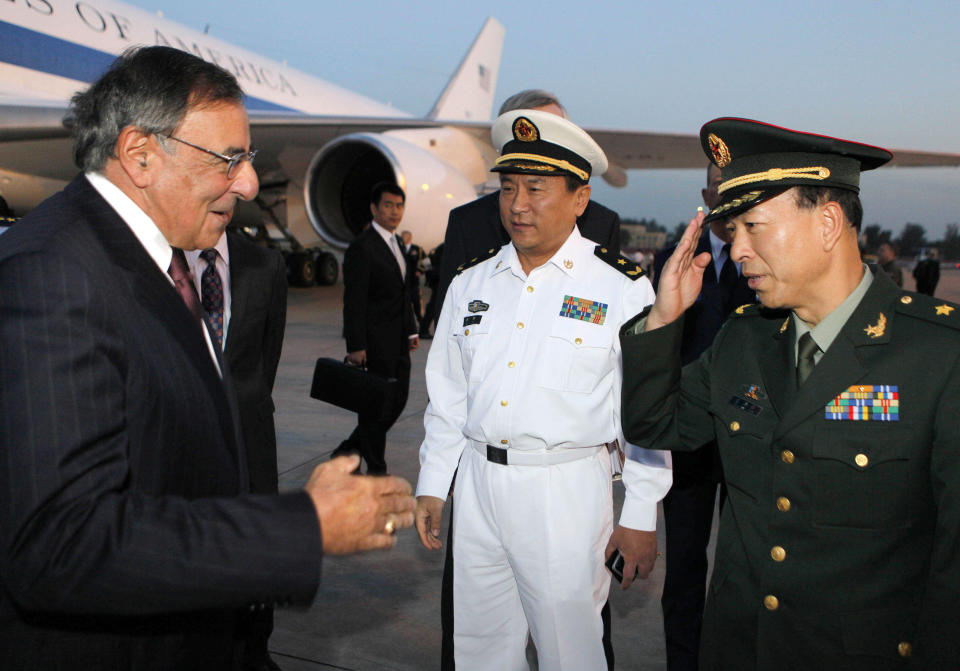 U.S. Secretary of Defense Leon Panetta, left, is welcomed by Chinese military leaders after his arrival at Beijing International Airport Monday, Sept. 17, 2012. Panetta is on his third trip to Asia in 11 months, reflecting the Pentagon's ongoing shift to put more military focus on the Asia-Pacific. (AP Photo/Larry Downing, Pool)