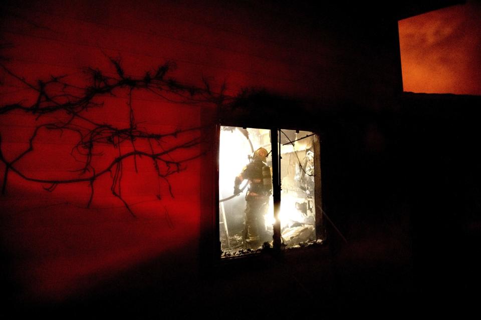 A firefighter inside a home