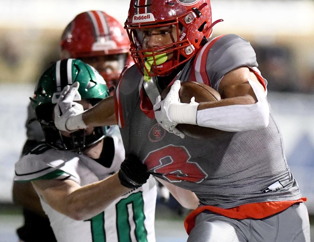 Canton South wide receiver Tavon Castle holds back West Branch linebacker Zachary Coffee for a first down in the second quarter of Division IV regional semifinal at Louisville Leopard Stadium. Friday, Nov. 10, 2023.