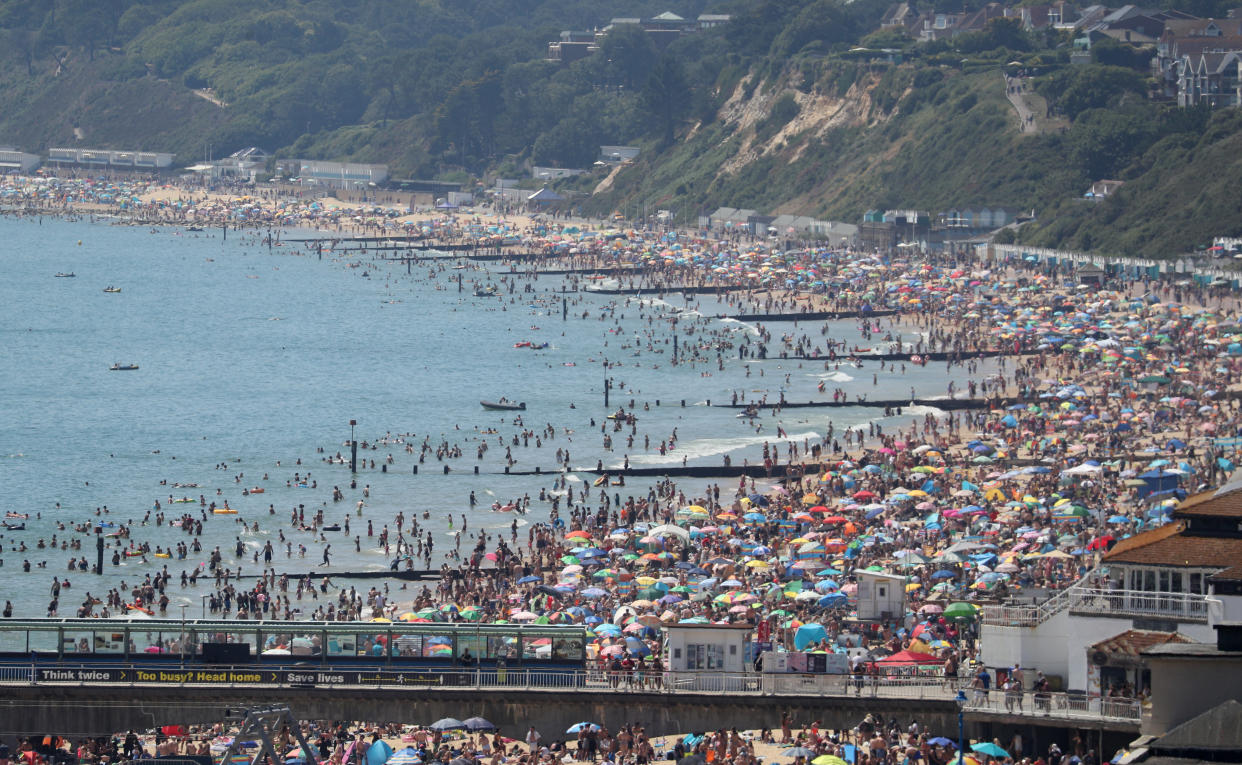 Crowds gather on the beach in Bournemouth as Thursday could be the UK's hottest day of the year with scorching temperatures forecast to rise even further. (Photo by Andrew Matthews/PA Images via Getty Images)