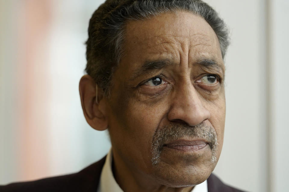 Nestor Castro, 67, of Cambridge, Mass., poses for a photo at Whittier Street Health Center, in Boston, on Thursday, March 31, 2022, where he volunteers. Just before Christmas in 2021, Castro got a permanent subsidized apartment through Hearth Inc., a Boston nonprofit dedicated to ending homelessness among older adults. (AP Photo/Steven Senne)