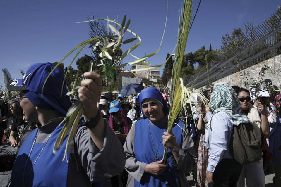 Nuns carry palm fronds as Christians walk in the Palm Sunday procession on the Mount of Olives in east Jerusalem, Sunday, April 2, 2023. The procession observes Jesus' entrance into Jerusalem in the time leading up to his crucifixion, which Christians mark on Good Friday. (AP Photo/Mahmoud Illean)