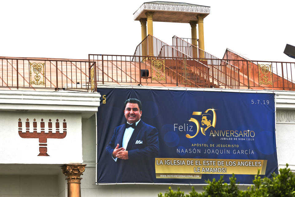 Mexico-based megachurch La Luz del Mundo, leader and self-proclaimed apostle Naasón Joaquín García's 50 birthday celebration portrait, is displayed on the side of the East Los Angeles temple on Friday, June 7, 2019. On Tuesday, April 7, 2020 a California appeals court dismissed the criminal case against the Mexican megachurch leader on charges of child rape and human trafficking. The case was dismissed on procedural grounds. García, the self-proclaimed apostle of La Luz del Mundo, has been in custody since June. He is currently being held without bail in Los Angeles. The attorney general's office said it was reviewing the court's ruling. (AP Photo/Damian Dovarganes)