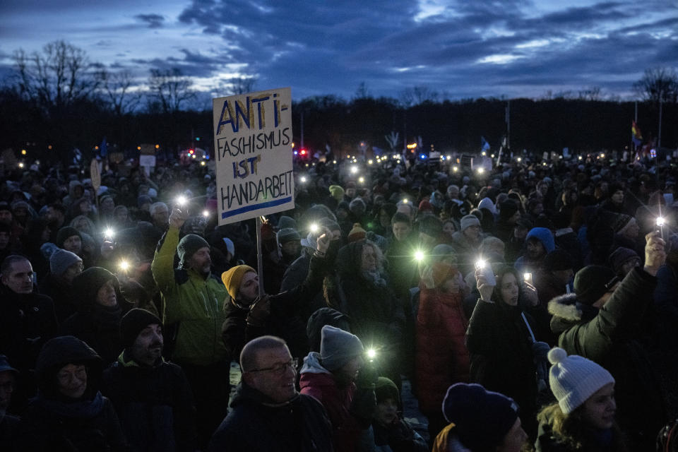 People gather to protest against the AfD party and right-wing extremism in front of the Reichstag building in Berlin, Germany, Sunday, Jan. 21, 2024. (AP Photo/Ebrahim Noroozi)