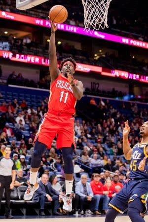 FILE PHOTO: Mar 6, 2019; New Orleans, LA, USA; New Orleans Pelicans guard Jrue Holiday (11) shoots the ball in front of Utah Jazz guard Donovan Mitchell (45) during the first half at Smoothie King Center. Stephen Lew/File Photo