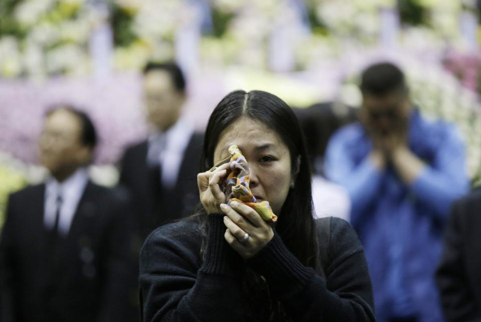 Lee Won-a, 40, wipes tear after she payed tribute to the victims of the sunken ferry Sewol, during a memorial altar in Ansan, south of Seoul, South Korea, Wednesday, April 30, 2014. Two weeks after the ferry sank off South Korea's southern cost, divers have recovered scores of bodies from the wreckage, but they fought strong currents and floating debris inside the ship Wednesday as they searched for the rest still missing. (AP Photo/Lee Jin-man)