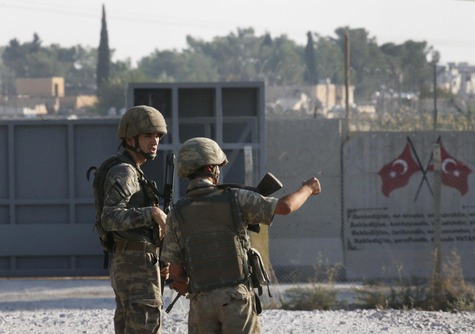 Shortly after the Turkish operation inside Syria had started, Turkish soldier stand at the border with Syria in Akcakale, Sanliurfa province, southeastern Turkey, Wednesday, Oct. 9, 2019. Turkey launched a military operation Wednesday against Kurdish fighters in northeastern Syria after U.S. forces pulled back from the area, with a series of airstrikes hitting a town on Syria's northern border. (AP Photo/Lefteris Pitarakis)