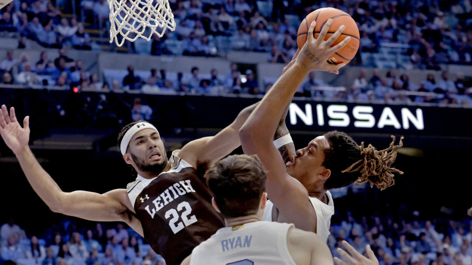 North Carolina forward Armando Bacot, right, grabs a rebound against Lehigh guard Tyler Whitney-Sidney (22) during the second half of an NCAA college basketball game Sunday, Nov. 12, 2023, in Chapel Hill, N.C. (AP Photo/Chris Seward)