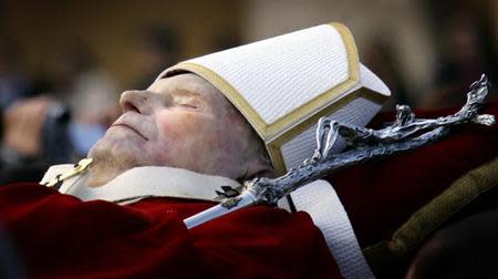 Pall bearers carry the body of the late Pope John Paul II through a packed Saint Peter's Square at the Vatican. REUTERS/Kai Pfaffenbach