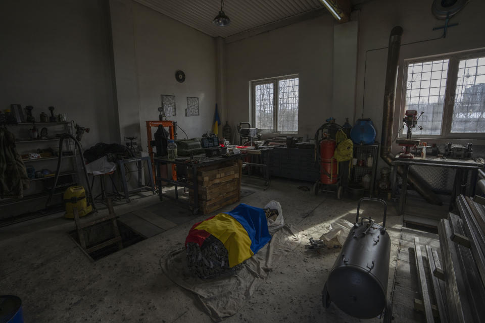 A Ukrainian flag placed over the Ukrainian Insurgent Army flag, sit on items that will be sent to soldiers on the frontlines, at a car welding workshop in Lviv, western Ukraine, Sunday, March 27, 2022. Ukraine’s military has put up a resistance to Russia’s invasion that has surprised some observers. One of its weapons is a parallel army of volunteers who are busy mobilizing funding and supplies ranging from body armor to cigarettes. (AP Photo/Nariman El-Mofty)