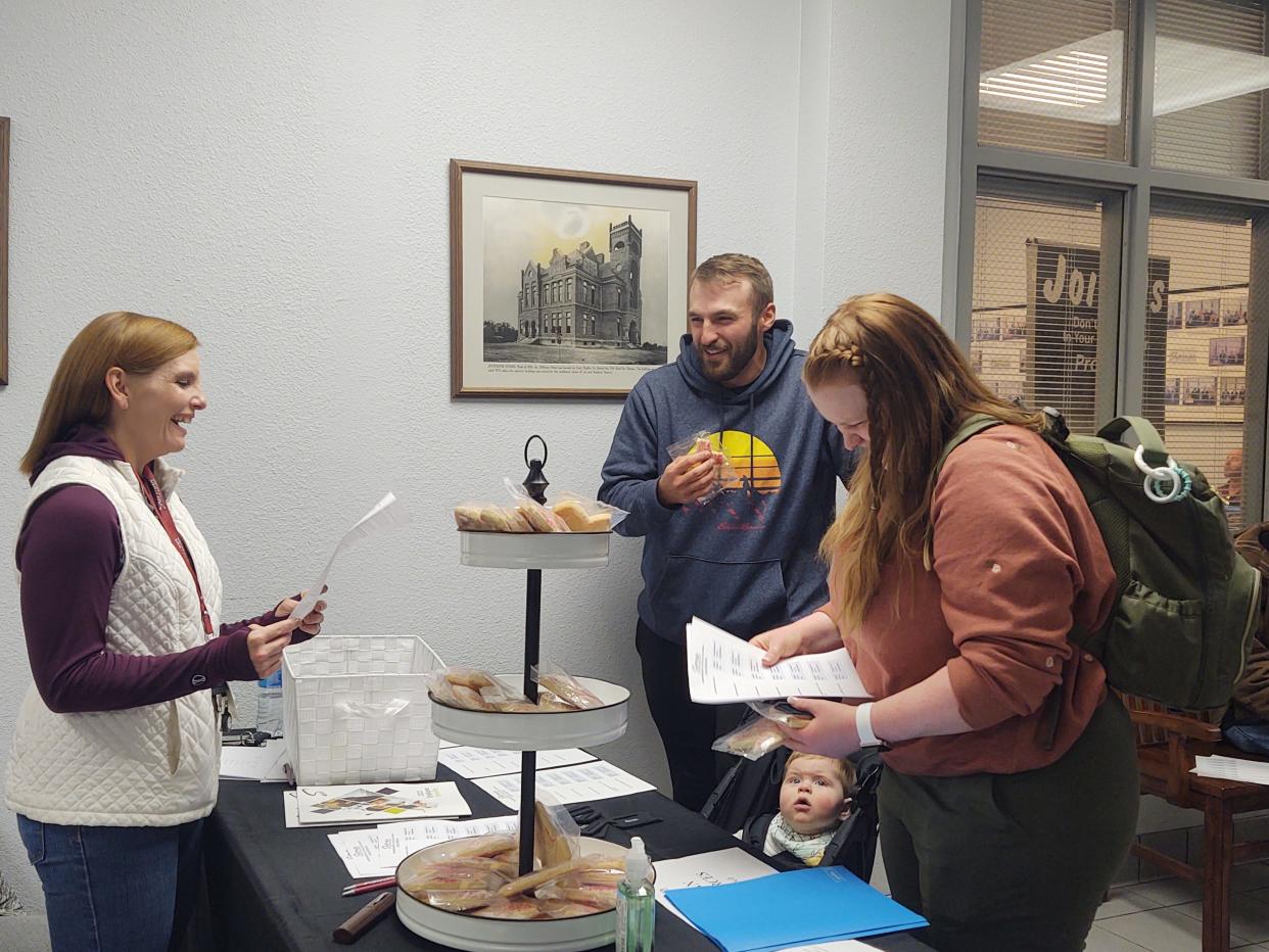 Jobseekers  visit with managers with the city of Sherman during a job fair in February. The regional unemployment rate rose slightly in January following the end of the holiday shopping season.