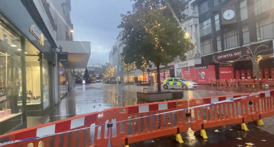 Police cordoned off a section of Liverpool city after Ava White, a 12-year-old girl, was stabbed. A police car can be seen behind an orange barricade.