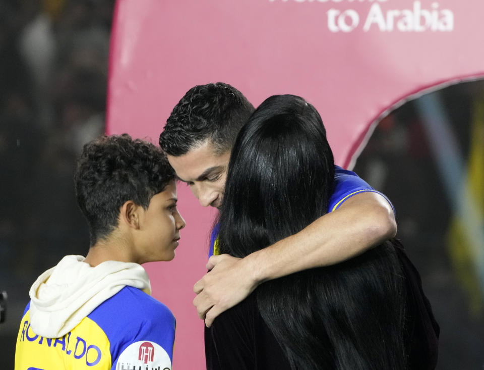 Cristiano Ronaldo hugs Georgina Rodriguez as they attend the official unveiling as a new member of Al Nassr soccer club in in Riyadh, Saudi Arabia, Tuesday, Jan. 3, 2023. Ronaldo, who has won five Ballon d'Ors awards for the best soccer player in the world and five Champions League titles, will play outside of Europe for the first time in his storied career. (AP Photo/Amr Nabil)