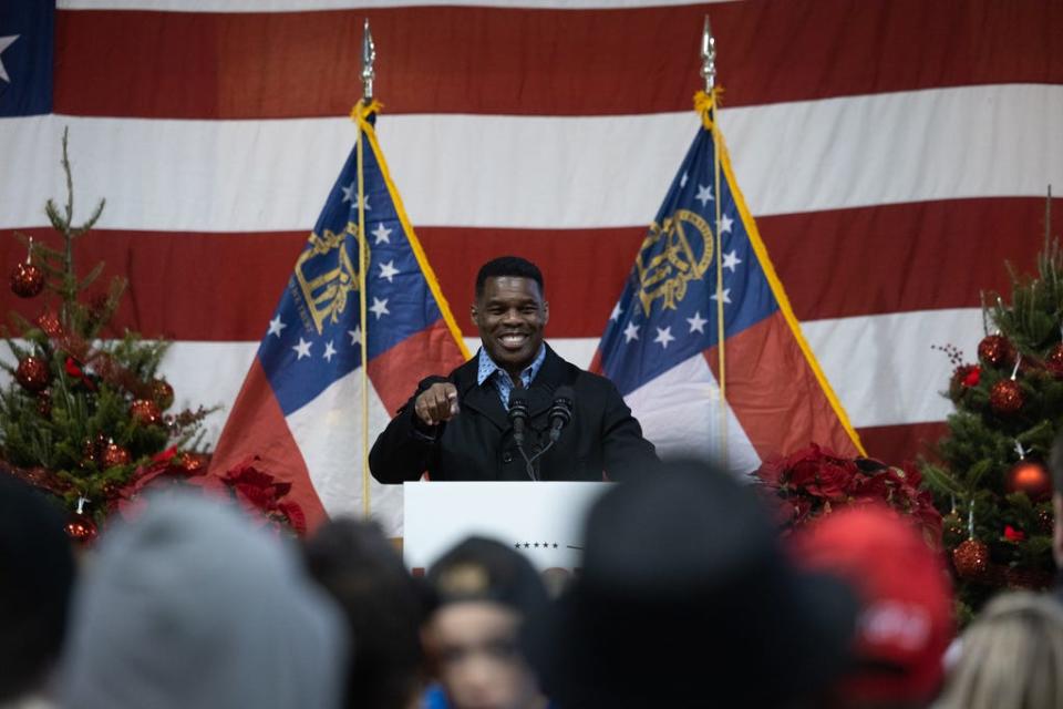 Republican Senate nominee Herschel Walker speaks to a crowd gathered for a rally with prominent Republicans on November 21, 2022 in Milton, Georgia.