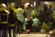 REFILE - ADDING SLUG People receive medical attention after part of the ceiling at the Apollo Theatre on Shaftesbury Avenue collapsed in central London December 19, 2013. Emergency services said nearly 90 people had been injured in a packed London theatre on Thursday when part of the ceiling collapsed during a performance, bringing the city's West End theatre district to a standstill.The audience was showered with masonry and debris following the incident at the Apollo Theatre, where about 720 people including many families were watching the hugely popular play "The Curious Incident of the Dog in the Night-Time". REUTERS/Neil Hall (BRITAIN - Tags: DISASTER ENTERTAINMENT)