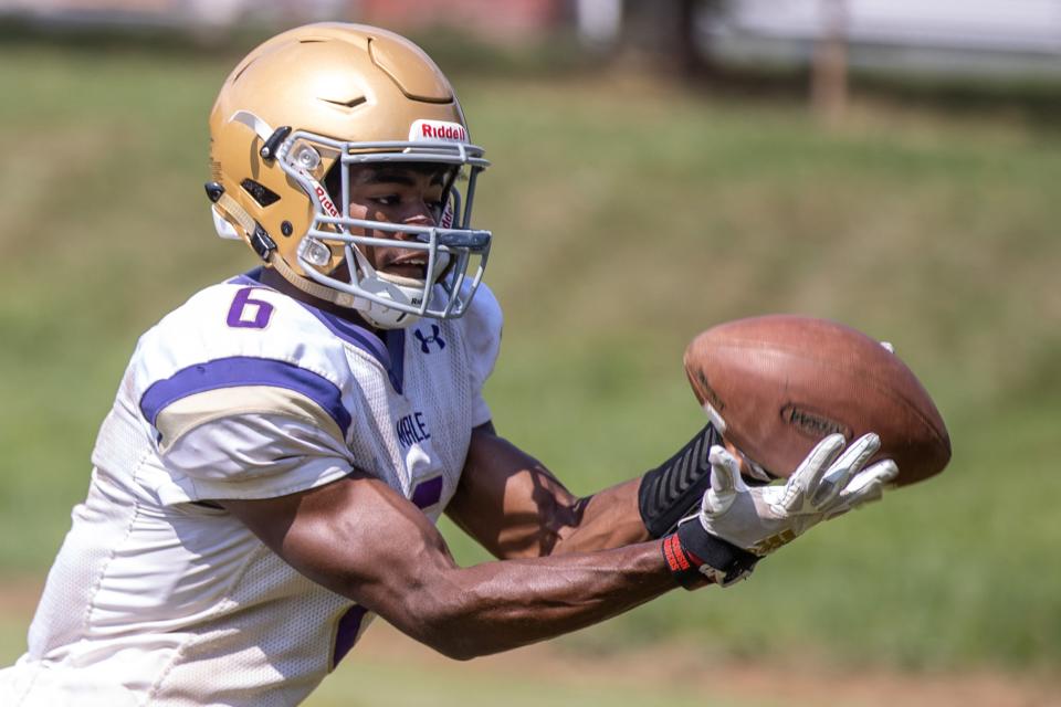 Wide receiver Vinny Anthony catches passes during a Louisville Male football practice Wednesday afternoon. Aug. 4, 2021