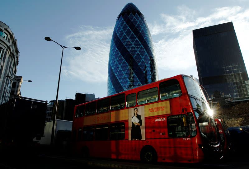 FILE PHOTO: Bus passes the building known as the Gherkin in the City of London