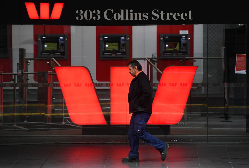 A man walks past a Westpac bank sign in Melbourne's central business district on May 4, 2020. - Westpac on May 4 announced its half-year net profit had fallen 62 percent, making it the latest Australian bank to see profits dive during the coronavirus crisis. (Photo by William WEST / AFP) (Photo by WILLIAM WEST/AFP via Getty Images)