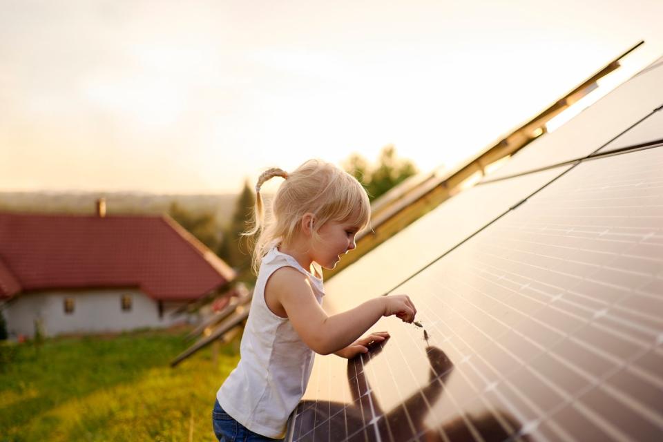 A child playing with a solar panel.