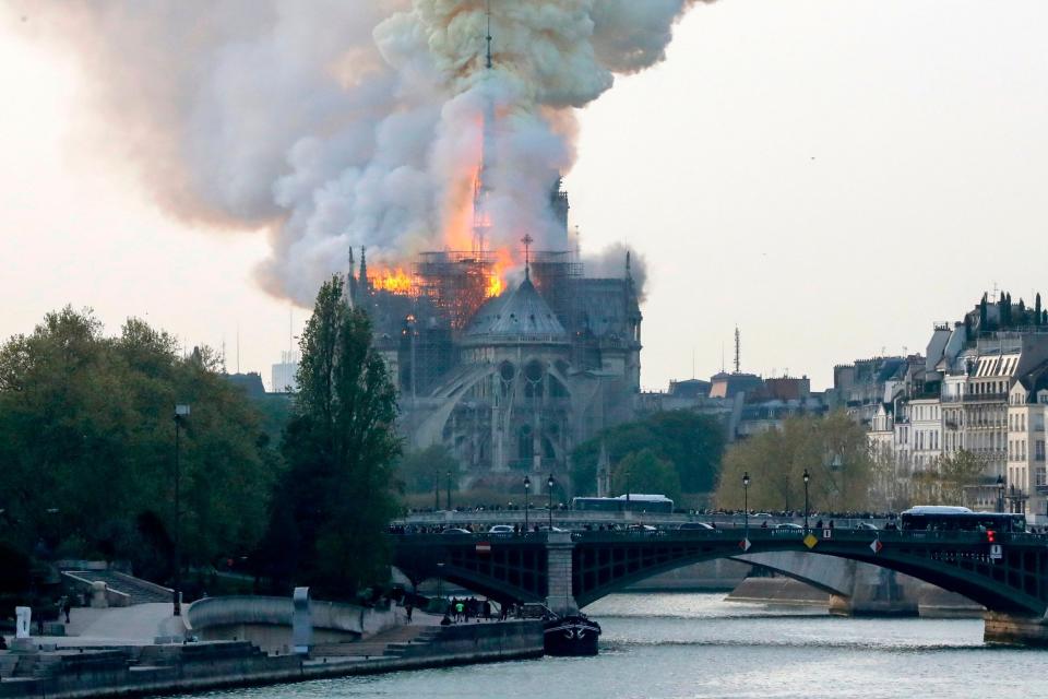Smoke billows into the sky as a fire rips through iconic landmark Notre Dame cathedral in Paris (AFP/Getty Images)