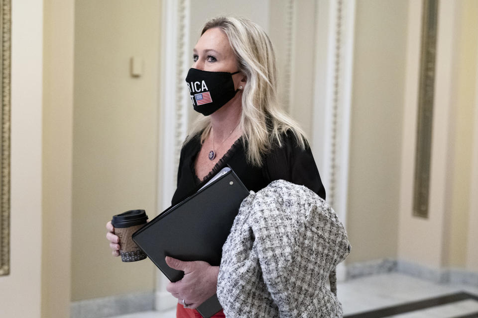 Freshman Rep. Marjorie Taylor Greene, R-Ga., walks past the House chamber at the Capitol in Washington, Wednesday, March 17, 2021. (AP Photo/J. Scott Applewhite)