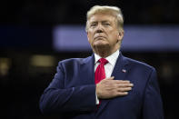 President Donald Trump stands for the national anthem before the beginning of the College Football Playoff National Championship game between LSU and Clemson, Monday, Jan. 13, 2020, in New Orleans. (AP Photo/ Evan Vucci)