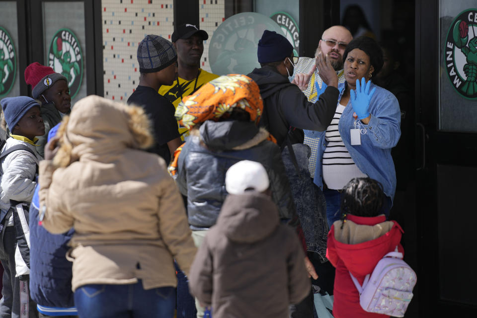 Asylum seekers are given instructions upon arriving at the Portland, Expo, Monday, April 10, 2023, in Portland, Maine. The state is reopening a basketball arena for immigrants following the arrival of more than 800 asylum seekers since the beginning of the year. (AP Photo/Robert F. Bukaty)
