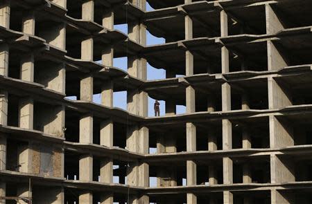 A worker stands at the site of a residential complex which is under construction in Kabul May 14, 2014. REUTERS/Omar Sobhani