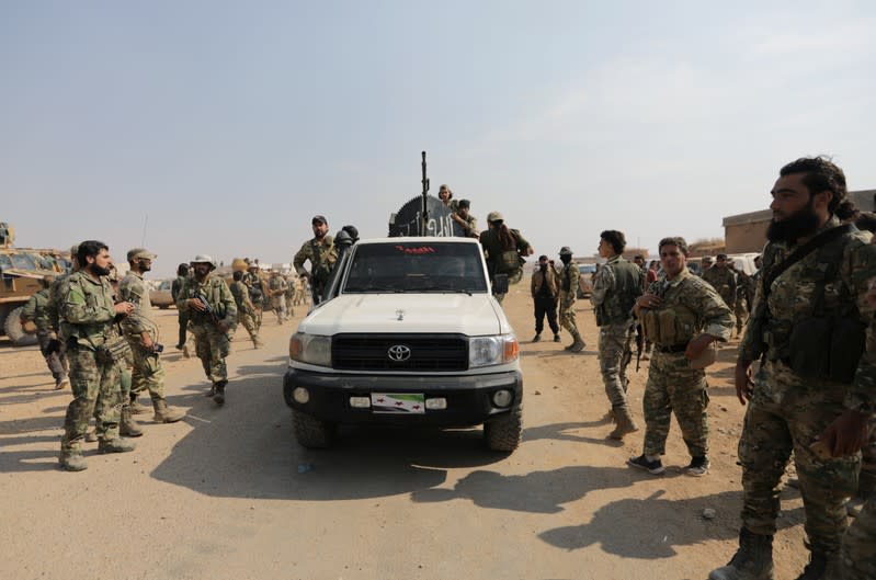 Turkey-backed Syrian rebel fighters gather near the border town of Tal Abyad