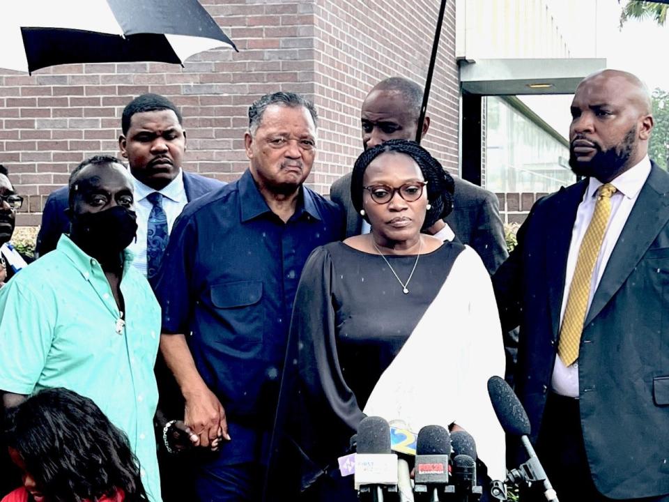 Wanda Cooper-Jones and Marcus Arbery, the parents of Ahmaud Arbery, are flanked by civil rights leader Jesse Jackson and attorney Lee Merritt while addressing the media after the sentencing of their son's killers in federal court in Brunswick, Ga., on Aug. 8.