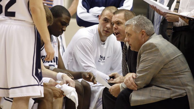 BYU assistant coach John Wardenburg, right and head coach Dave Rose, second from right, talk to the team during a timeout as BYU faces Western Oregon in Provo on Jan. 6, 2009. Wardenburg has returned to BYU, but this time as an assistant on the women’s team.