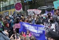 FILE - Climate activist Greta Thunberg, center, demonstrates with others in front of the Standard and Chartered Bank during a climate protest in London, England, Oct. 29, 2021. AP Photo/Frank Augstein, File)