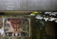 Handwritten notes left by fans are pictured on a fence at the site where Brazilian Formula One driver Ayrton Senna died at the race track in Imola April 22, 2014. REUTERS/Alessandro Garofalo