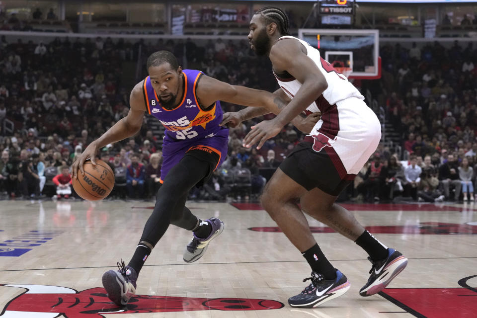 Phoenix Suns' Kevin Durant drives on Chicago Bulls' Patrick Williams during the first half of an NBA basketball game Friday, March 3, 2023, in Chicago. (AP Photo/Charles Rex Arbogast)