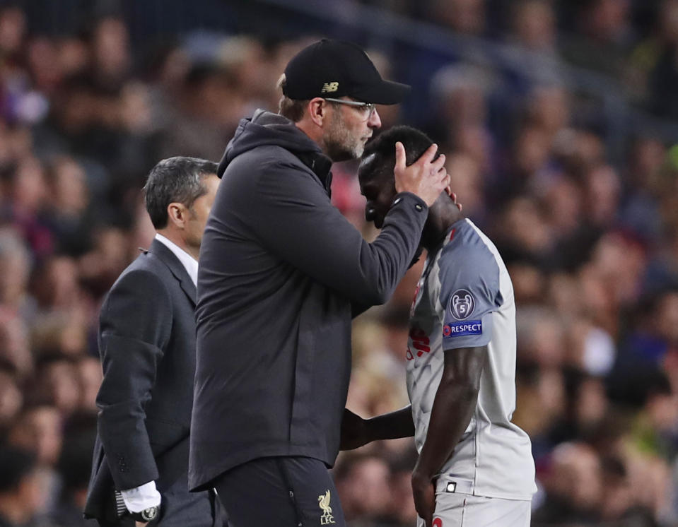 Liverpool's Naby Keita, right, is hugged by Liverpool coach Juergen Klopp as he walks off the pitch during the Champions League semifinal first leg soccer match between FC Barcelona and Liverpool at the Camp Nou stadium in Barcelona, Spain, Wednesday, May 1, 2019. (AP Photo/Manu Fernandez)