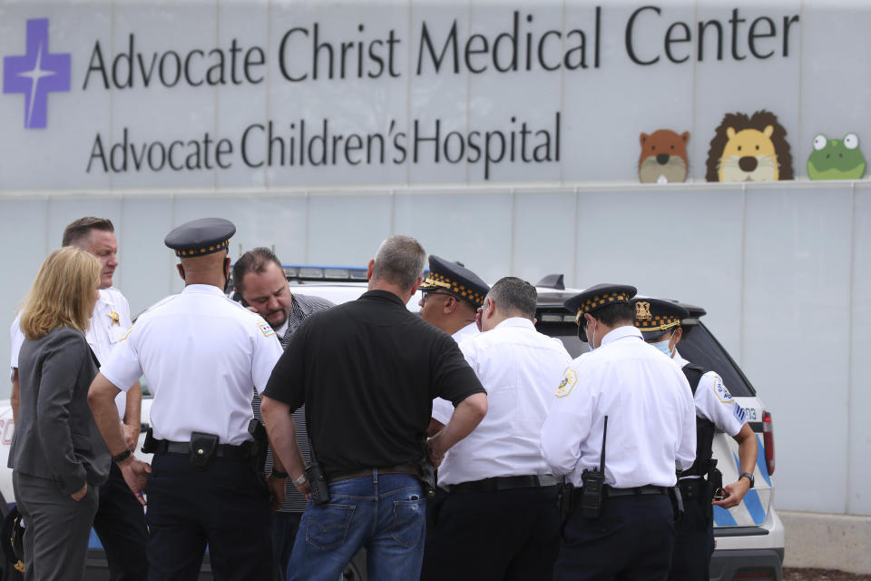 Police officers stand outside Advocate Christ Medical Center after multiple law enforcement officers were shot in the Morgan Park area of Chicago on Wednesday, July 7, 2021. Police say three undercover law enforcement officers were shot and wounded while driving onto an expressway on Chicago’s South Side. (Antonio Perez/Chicago Tribune via AP)