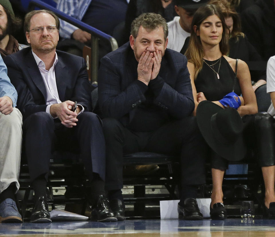 FILE - In this March 17, 2015, file photo, Madison Square Garden Chairman James Dolan, center, watches during the first half of an NBA basketball game against the San Antonio Spurs, in New York. Carmelo Anthony says the decision to issue an apology for his interaction with a fan was made by Madison Square Garden chairman James Dolan. Anthony told a heckling fan Tuesday, March 1, 2016, during the Knicks' loss to Portland to ask Dolan for his money back, pointing to the owner sitting nearby.  (AP Photo/Frank Franklin II)