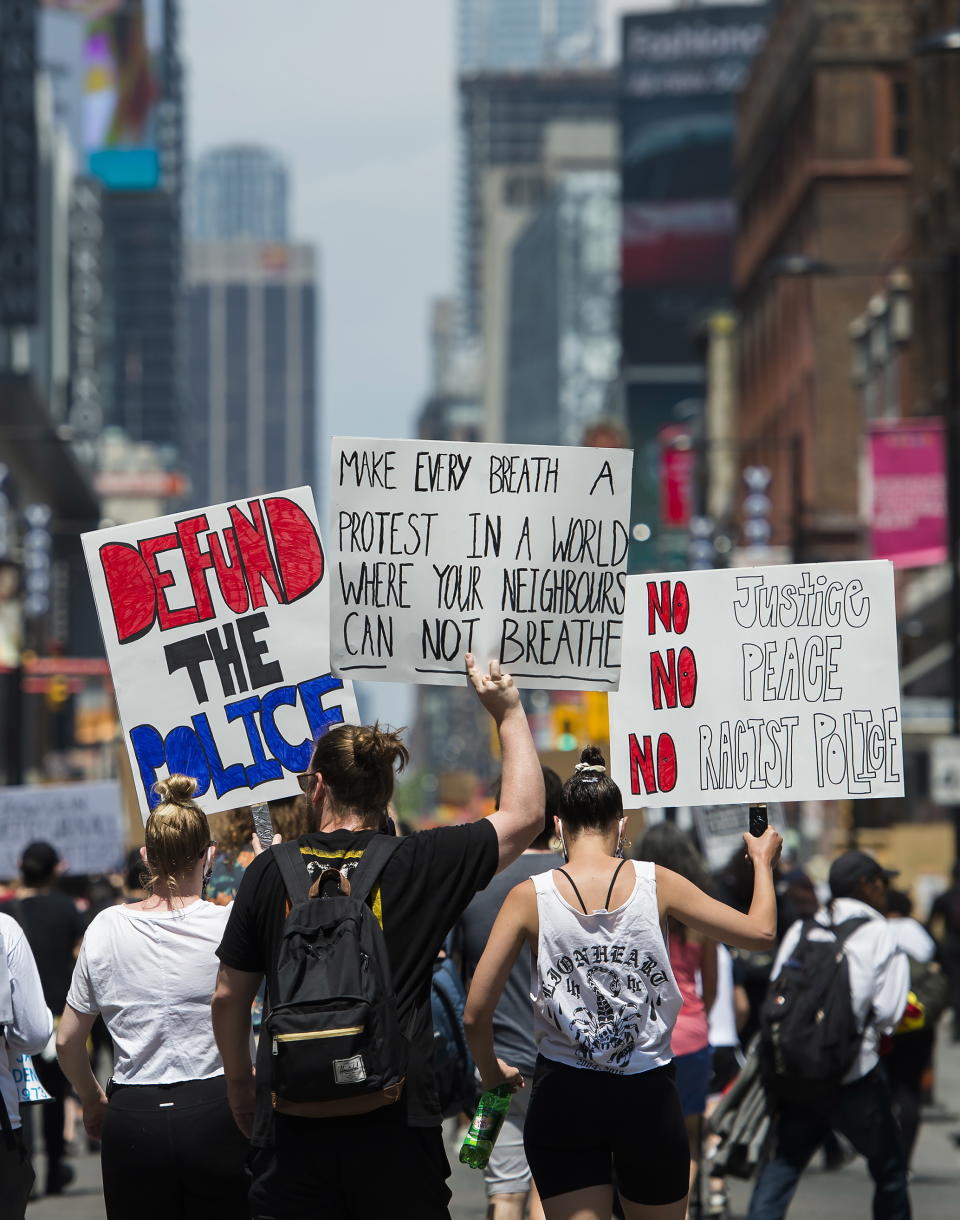 Thousands of people protest at an anti-racism demonstration reflecting anger at the police killings of black people in Toronto on Friday, June 5, 2020. (Nathan Denette/The Canadian Press via AP)